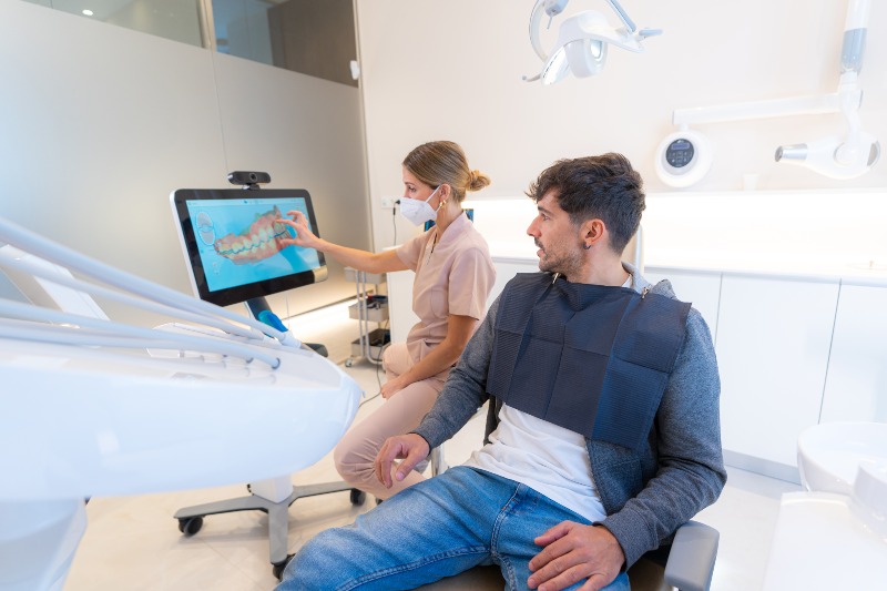 Dentist Showing Dental x ray to Patient
