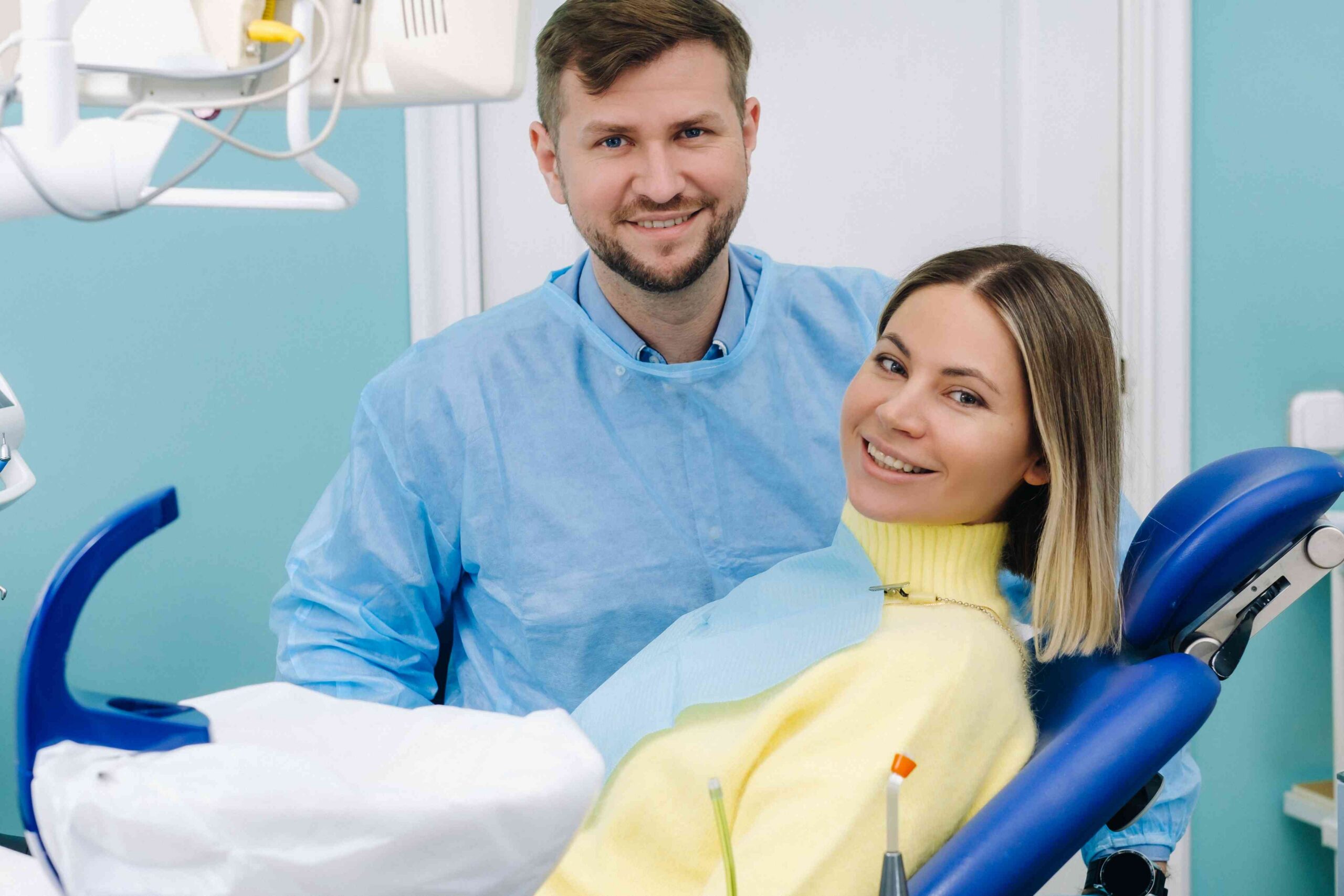 Smiling patient and dentist in a dental office.