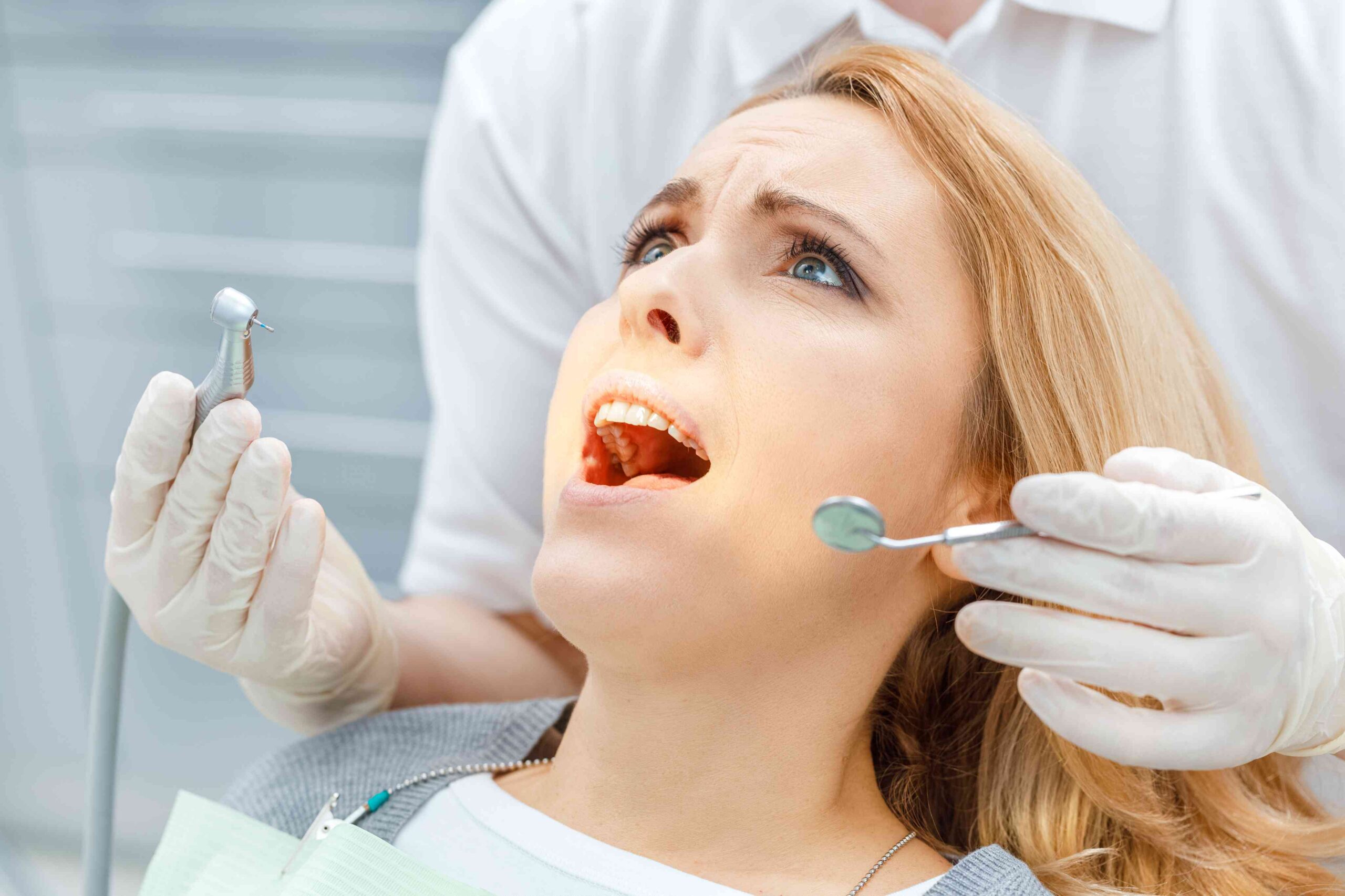 Dentist examining patient’s teeth